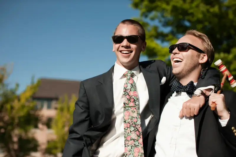 Laughing men hugging and holding croquet mallet
