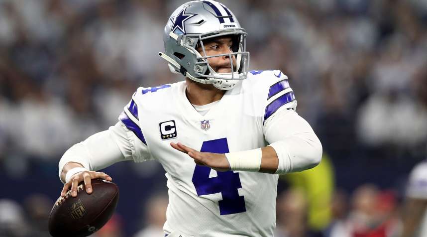 Dak Prescott of the Dallas Cowboys looks to pass against the Seattle Seahawks in the Wild Card playoff round on January 05, 2019 in Arlington, Texas.
