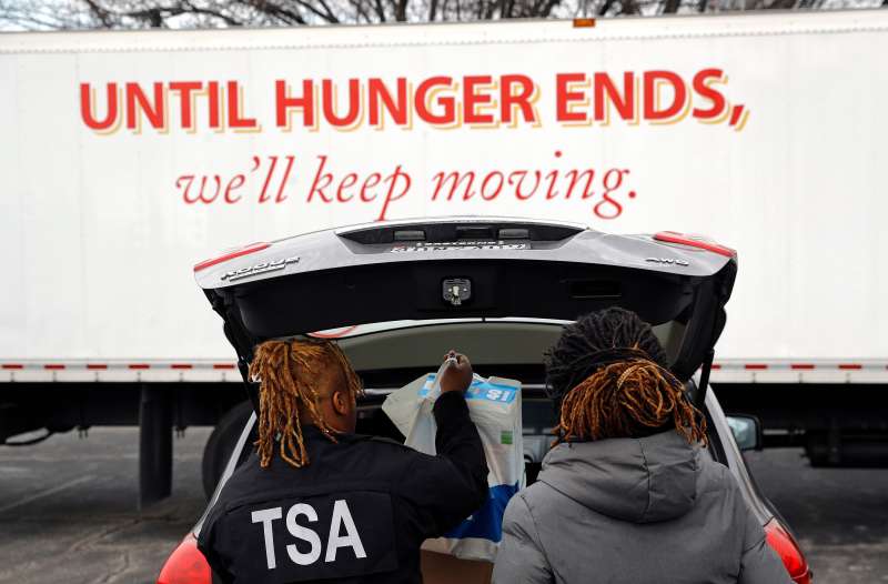 TSA employees Princess Young, left, and Erica Gibbs load food into a car after visiting a food pantry for furloughed government workers affected by the federal shutdown, in Baltimore Government Shutdown Maryland, Baltimore, January 23, 2019.
