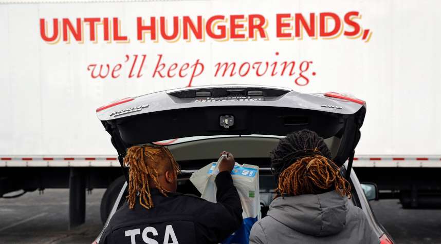 TSA employees Princess Young, left, and Erica Gibbs load food into a car after visiting a food pantry for furloughed government workers affected by the federal shutdown, in Baltimore
                      Government Shutdown Maryland, Baltimore, January 23, 2019.