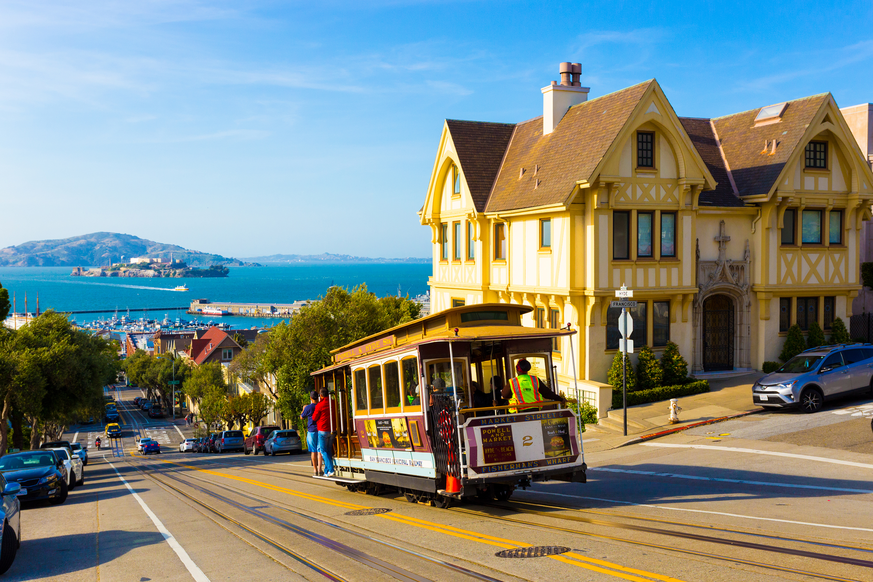 Combined scenic view of San Francisco Bay with Alcatraz, cable car, Victorian houses, typical iconic siteseeing landmarks and tourist attractions of the city