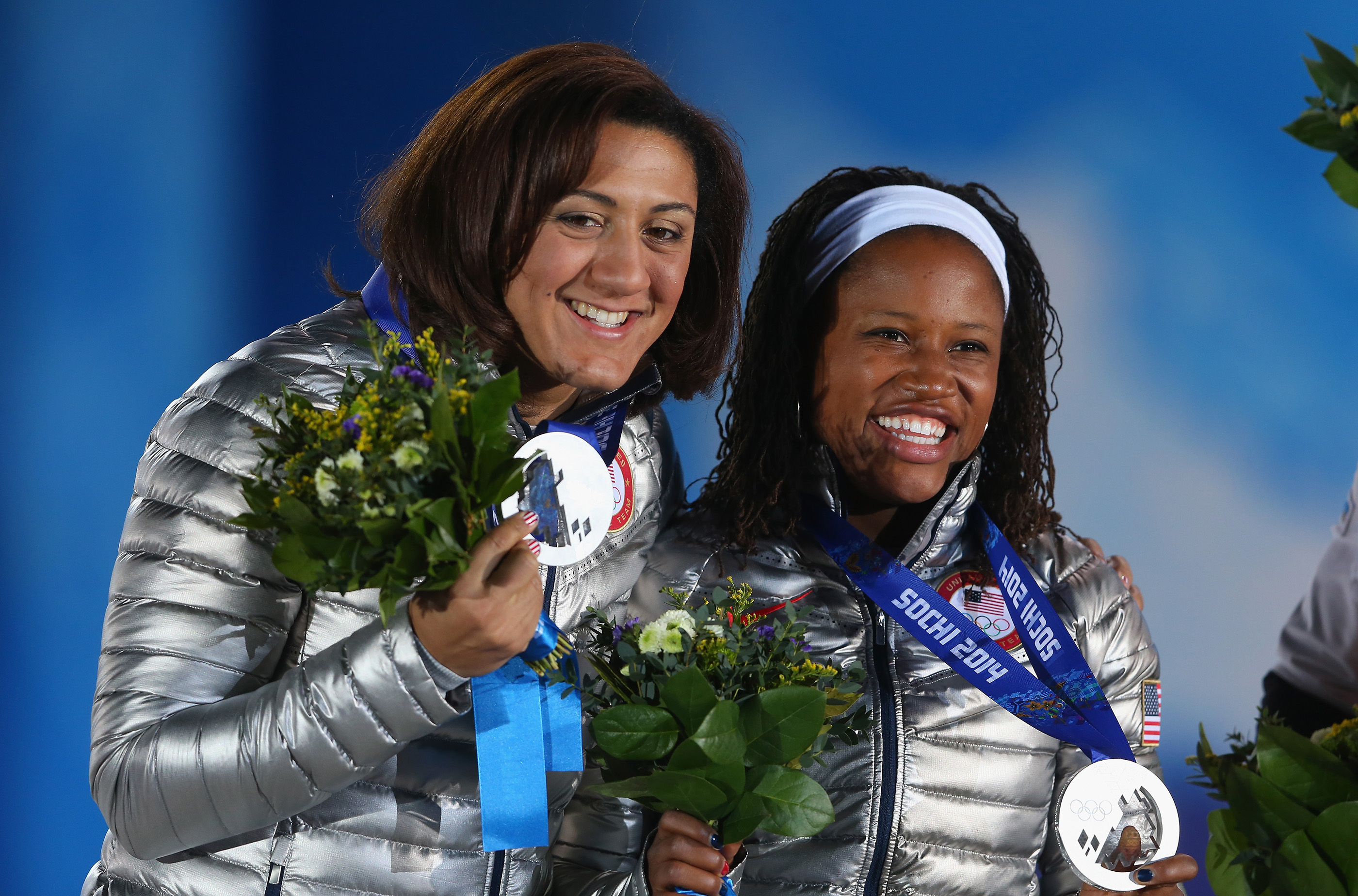 Silver medalists Elana Meyers (L) and Lauryn Williams of the United States team 1 celebrate during the medal ceremony for the Women's Bobsleigh on day thirteen of the Sochi 2014 Winter Olympics at at Medals Plaza on February 20, 2014 in Sochi, Russia.
