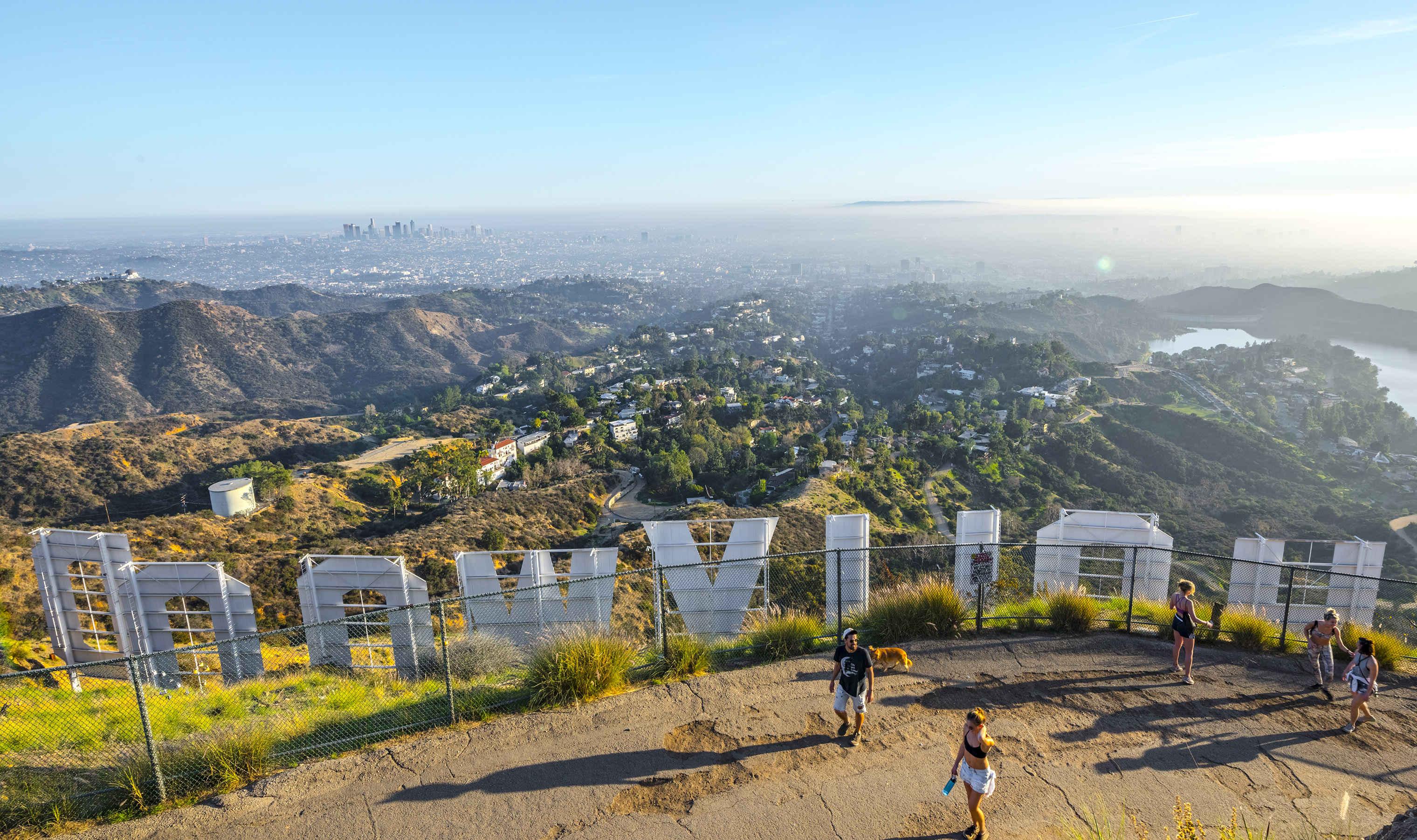 Hikers take in the view from the iconic Hollywood sign in the Hollywood Hills.