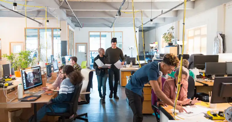Creative business people working in open plan office