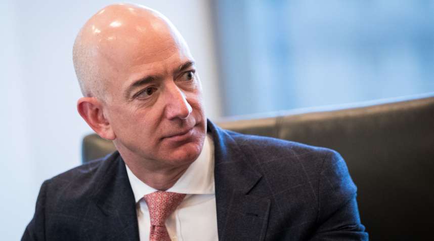 Jeff Bezos, CEO of Amazon, listens during a meeting of tech executives and President-elect Donald Trump at Trump Tower, December 14, 2016.