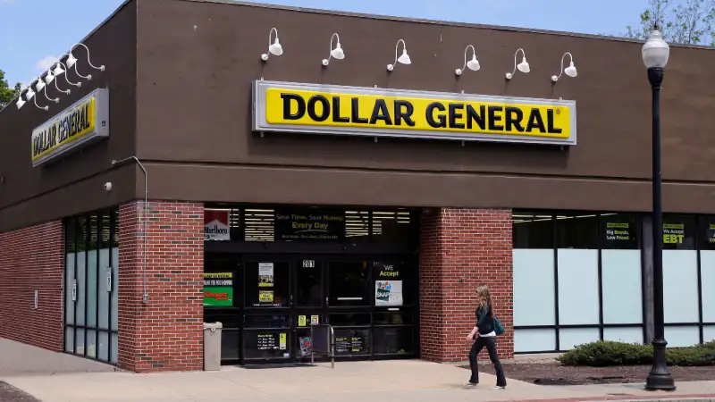 A woman walks past a Dollar General store in Methuen, Mass. On Thursday, May 26, 2016.