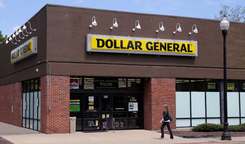 A woman walks past a Dollar General store in Methuen, Mass. On Thursday, May 26, 2016.
