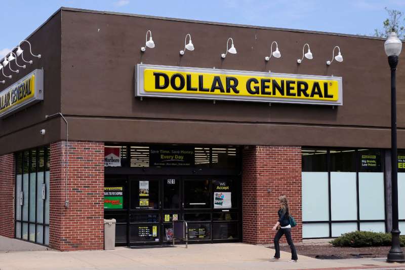 A woman walks past a Dollar General store in Methuen, Mass. On Thursday, May 26, 2016.