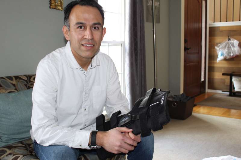 After a sports injury, Esteban Serrano owed $829.41 for a knee brace purchased with insurance through his doctor’s office. He says he found the same kind of braces selling for less than $250 online. (Paula Andalo/Kaiser Health News)