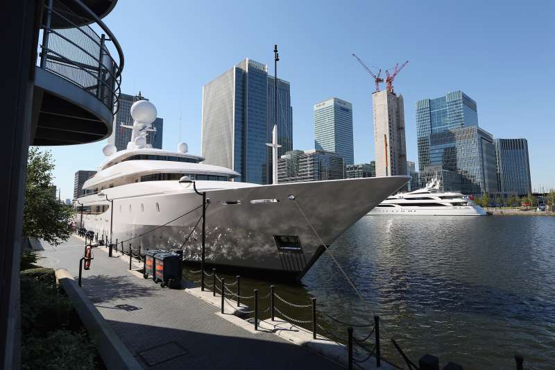 Large luxury yachts are moored in South Quay on the Isle of Dogs in London, England.