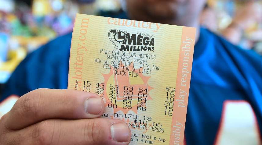 A man shows his lottery tickets on October 23, 2018 ahead of the drawing for the $1.5 billion Mega Millions jackpot.