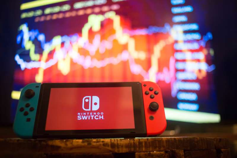 A Nintendo Switch displays the Nintendo Switch logo with a