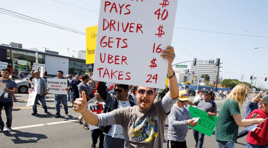 Rideshare drivers from the Los Angeles area protest during a one-day strike outside the Uber Greenlight offices in Redondo Beach, Calif.