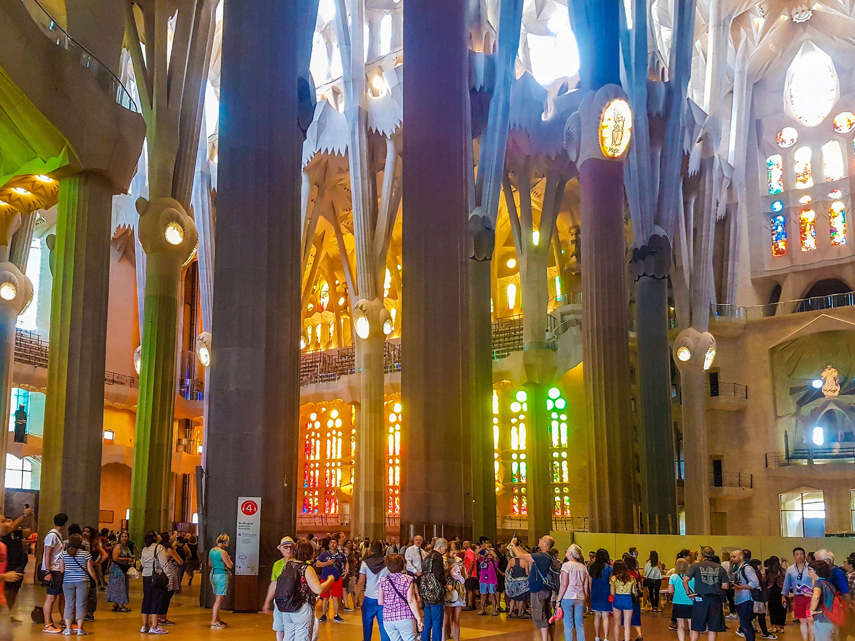 Tourists inside the Sagrada Familia Cathedral, designed by Antoni Gaudi, UNESCO World heritage site, Barcelona, Spain