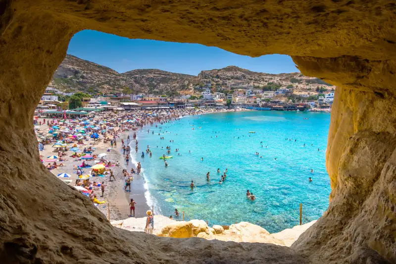 Matala beach with caves on the rocks that were used as a roman cemetery and at the decade of 70's were living hippies from all over the world, Crete, Greece