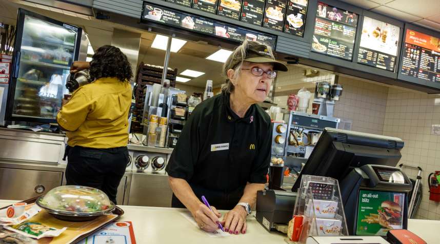 Senior woman working in McDonald's fast food restaurant (Photo by: Jeffrey Greenberg/UIG via Getty Images)