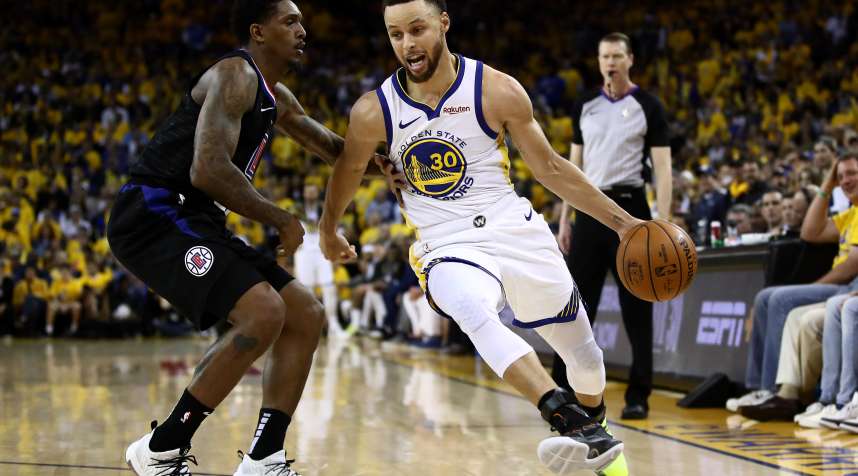 Stephen Curry of the Golden State Warriors drives on Lou Williams of the LA Clippers during Game One of their 2019 NBA playoff series, on April 13, 2019.