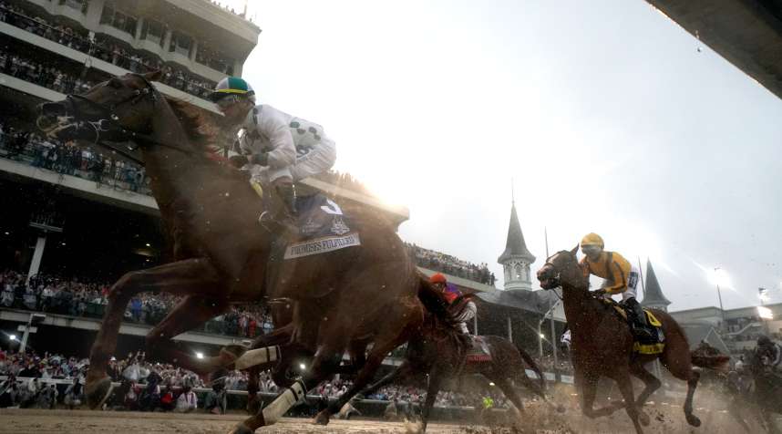 Horses racing during the first turn of the 144th running of the Kentucky Derby at Churchill Downs in 2018.