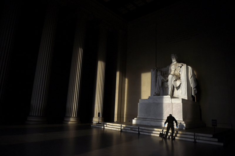 A cleaner sweeps the floor in front of the Lincoln Memorial in Washington