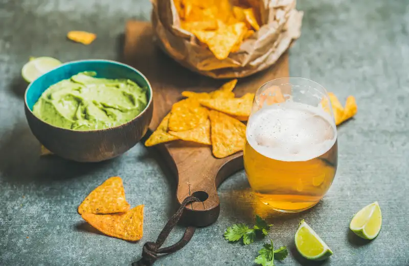 Mexican corn chips, fresh lime, guacamole sauce and wheat beer