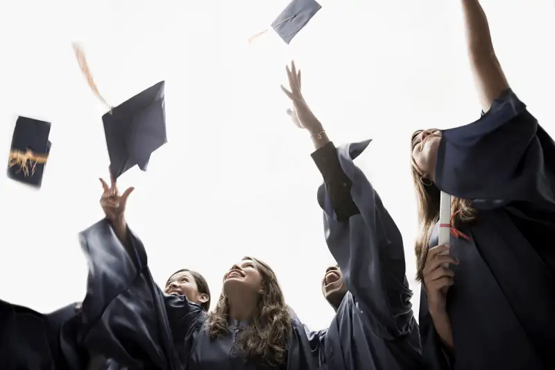 Graduates throwing mortarboards