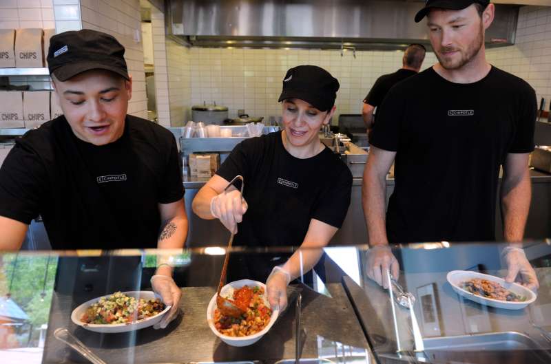 Employees at the Chipotle restaurant in LoDo at 1480 16th ST. in Denver perform all the prep work needed to get ready for the lunch crowd on Friday, June 29, 2012. Getting ready for the shift meeting are from left to right, Josh Pisani, Angelica Mora, and