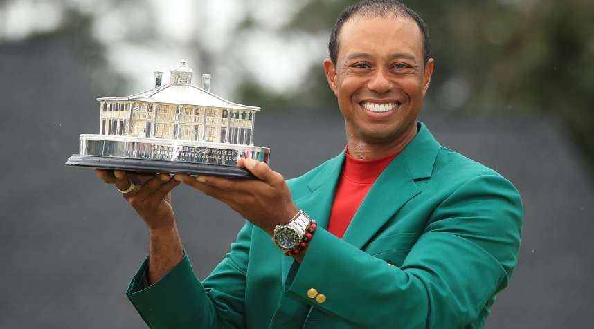 Tiger Woods celebrates with the Masters Trophy during the Green Jacket Ceremony after winning the Masters at Augusta National Golf Club on April 14, 2019.
