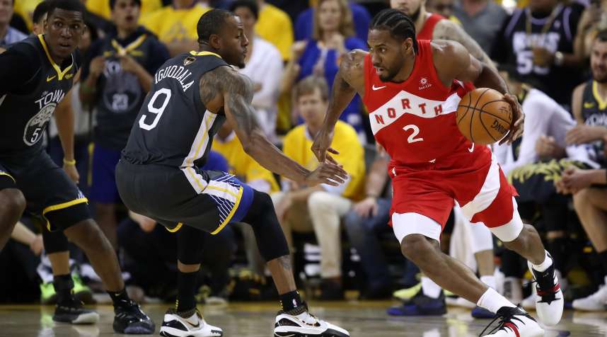 Kawhi Leonard of the Toronto Raptors is defended by Andre Iguodala of the Golden State Warriors in the first half during Game Four of the 2019 NBA Finals.