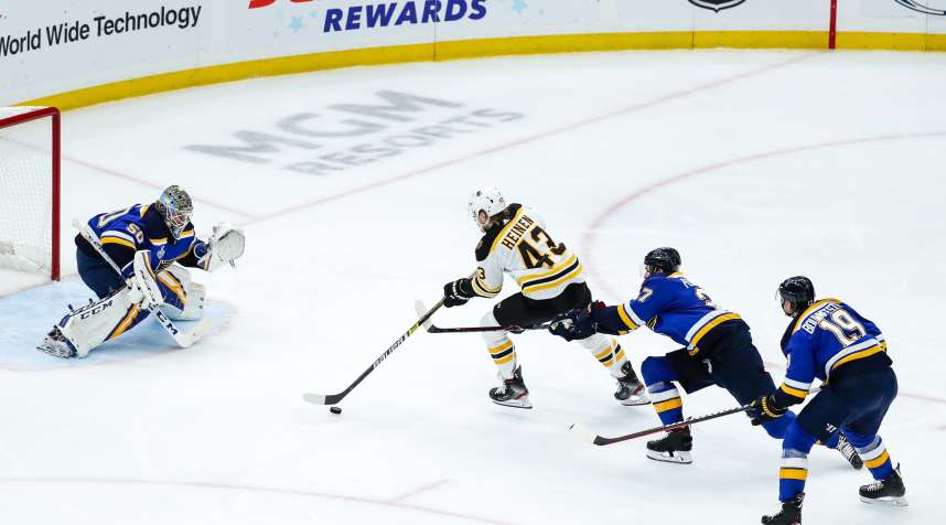 Boston Bruins' Danton Heinen skates in on a breakaway and has his stick lifted by St. Louis Blues' Alex Pietrangelo, center right, in front of Blues goaltender Jordan Binnington during Game 6 of the NHL Stanley Cup Finals.