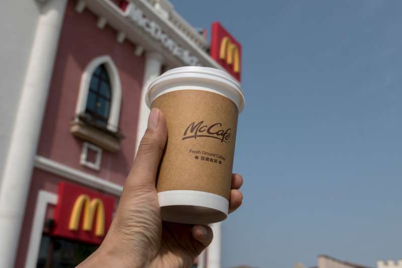 A Chinese customer buys a cup of McDonald's coffee.  In