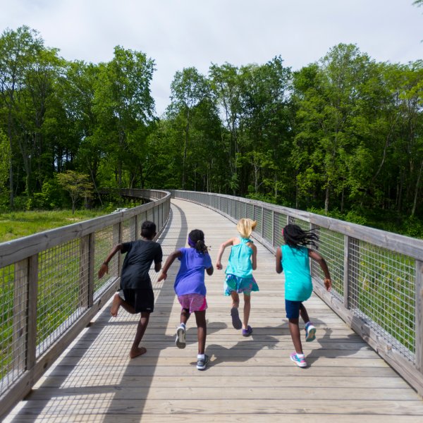 children running on a bridge in Fishers, Indiana