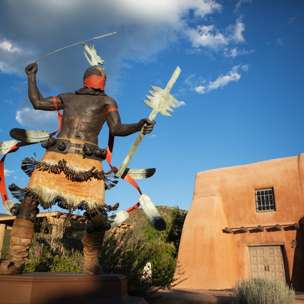 Pueblo style home and sculpture in Santa Fe, New Mexico