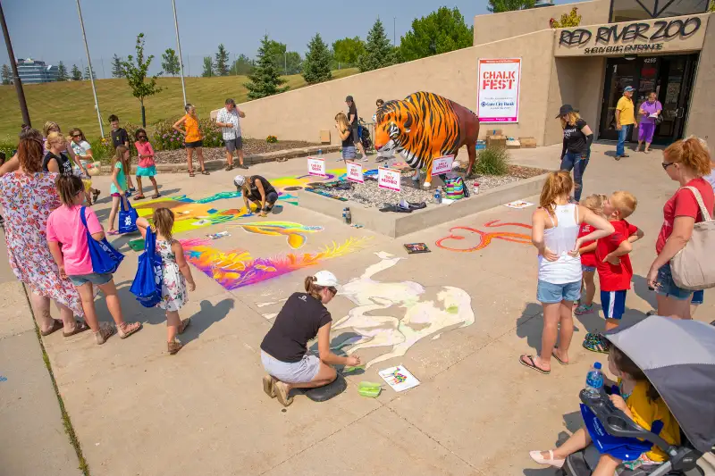 Children playing with sidewalk chalk in Fargo, North Dakota