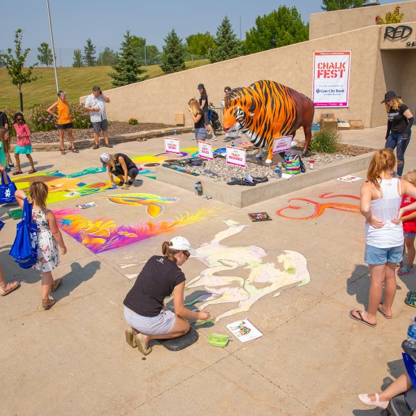 Children playing with sidewalk chalk in Fargo, North Dakota