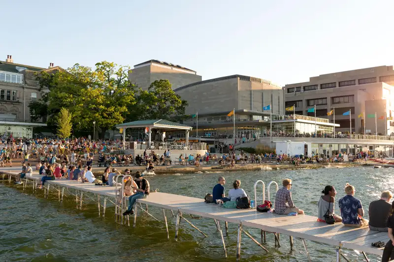 People sitting on the dock of Madison, Wisconsin lakefront