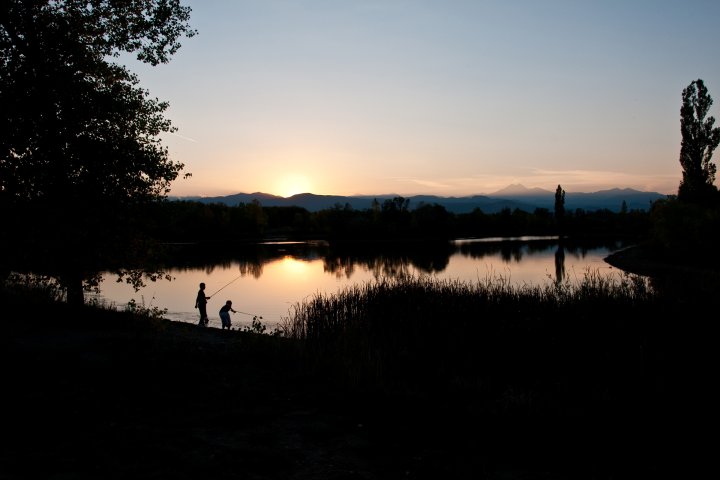 Two people fishing at sunset in longmont, colorado
