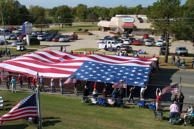 community holding large american flag in Midwest City, Oklahoma