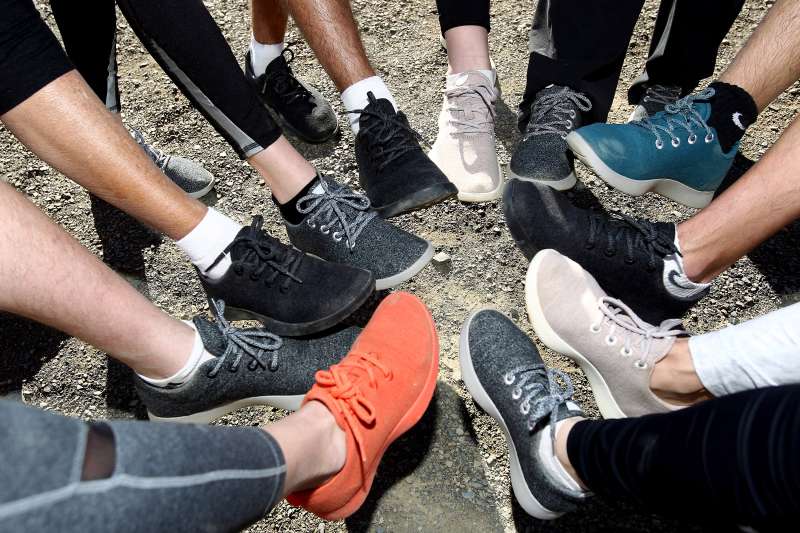 Hikers showing off their Allbirds shoes.