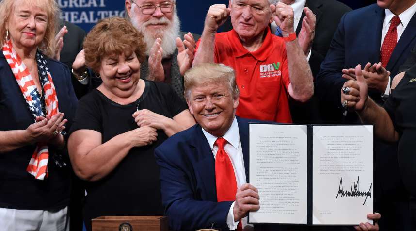 THE VILLAGES, FLORIDA, UNITED STATES - 2019/10/03: U.S. President Donald Trump signs an executive order to protect and improve Medicare at the Sharon L. Morse Performing Arts Center.