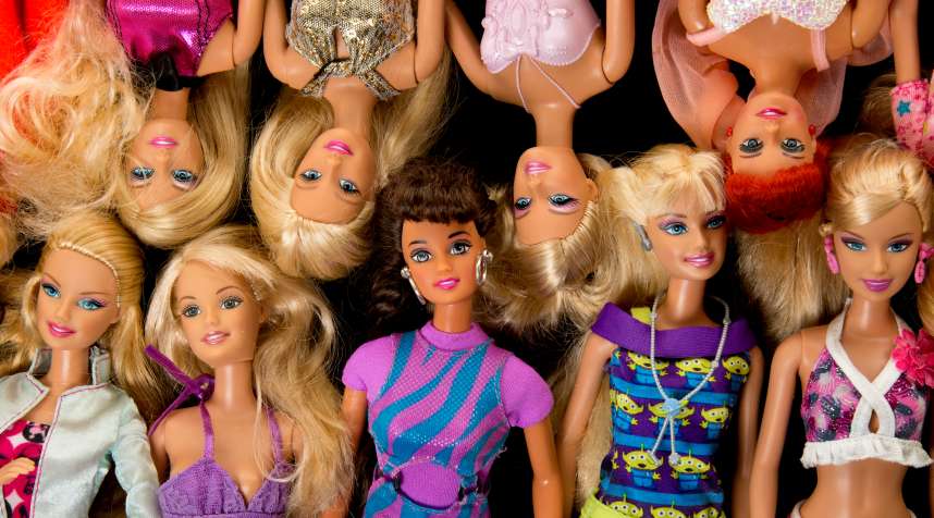 A pile of Barbie fashion dolls.
