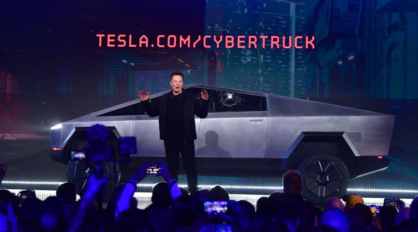 Tesla co-founder and CEO Elon Musk speaks in front of the newly unveiled all-electric battery-powered Tesla Cybertruck.