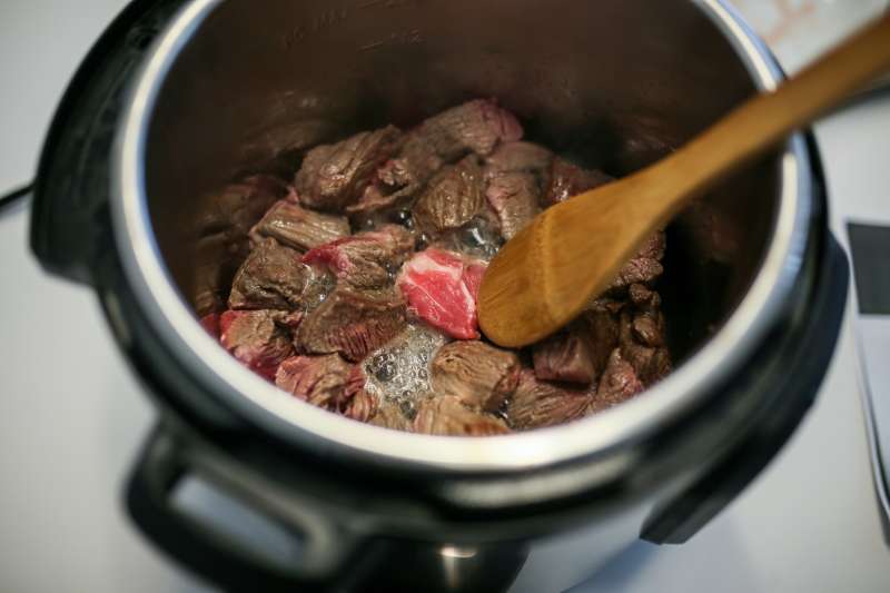 Cubes of beef are sauteed in the Instant Pot.