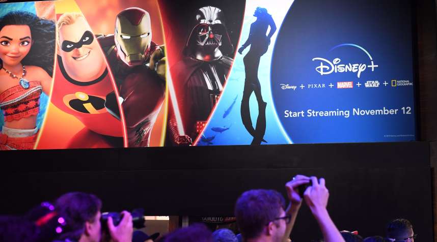 Attendees visit the Disney+ streaming service booth at the D23 Expo on August 23, 2019 at the Anaheim Convention Center in California.
