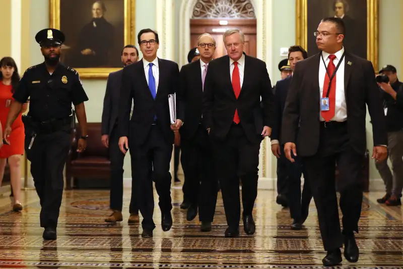 WASHINGTON, DC - MARCH 24: Treasury Secretary Steven Mnuchin (2L), White House Director of Legislative Affairs Eric Ueland (3L) and White House Chief of Staff Mark Meadows (4L) arrive at the U.S. Capitol.