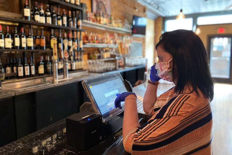 Claire Zielinski works a restaurant shift in Bay City, Michigan on June 9, 2020. She's one of thousands of Americans enrolled in a little-known federal program that helps workers qualify for unemployment insurance after they return to work.