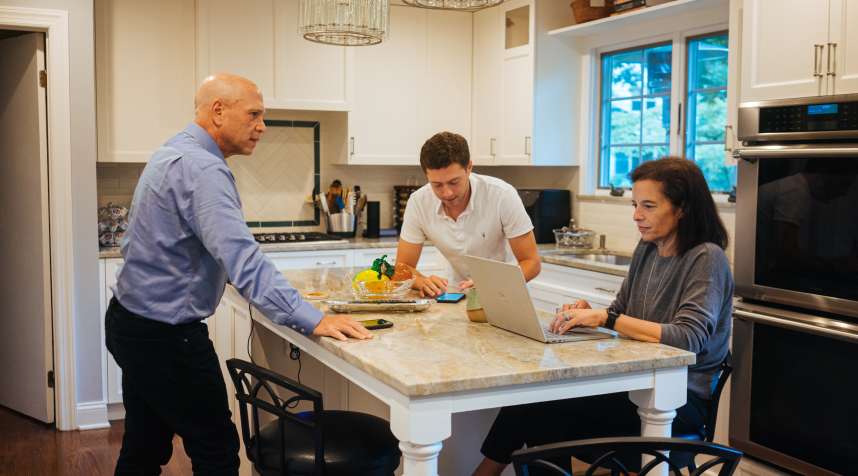 Lynn Pollack with her son and husband in their kitchen, September 2, 2020.