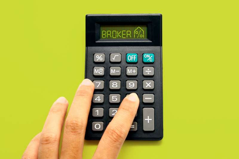 Calculator with the word broker on it on a green background