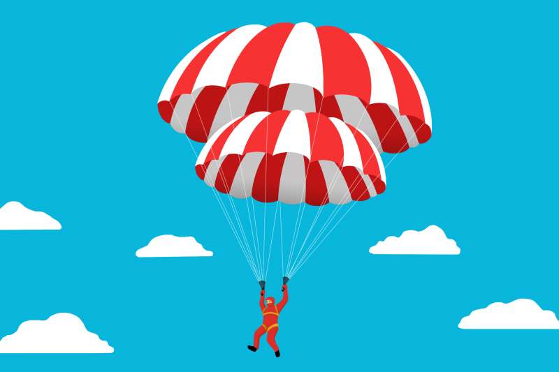 A person with two parachutes coming down from the sky.