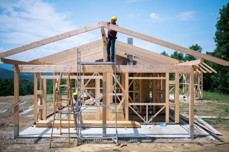 Builders working on wooden construction site