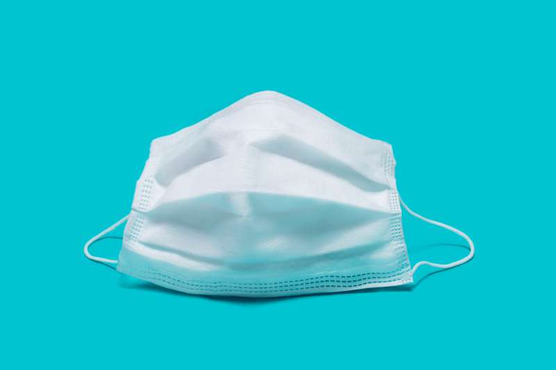 Surgical mask on a colored background